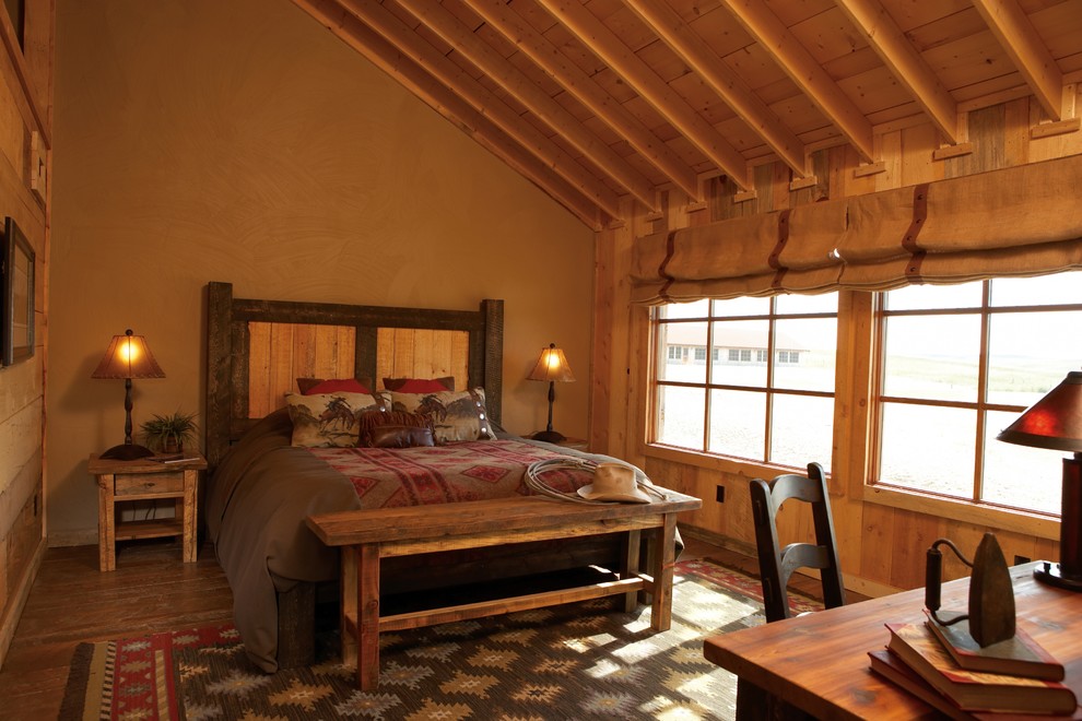 Mittelgroßes Uriges Hauptschlafzimmer ohne Kamin mit beiger Wandfarbe, braunem Holzboden und braunem Boden in Denver
