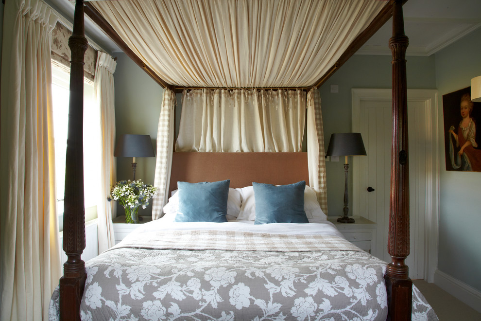 Medium sized country guest bedroom in Wiltshire with blue walls and carpet.