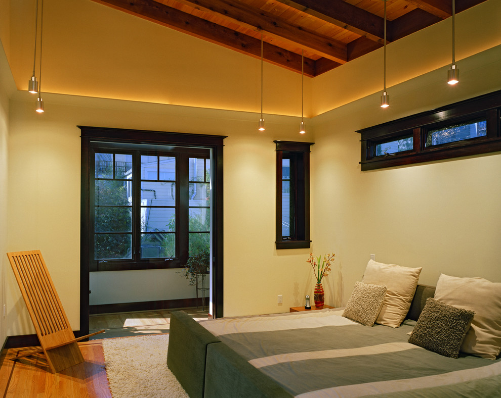 Idées déco pour une chambre contemporaine avec un mur beige, un sol en bois brun et aucune cheminée.