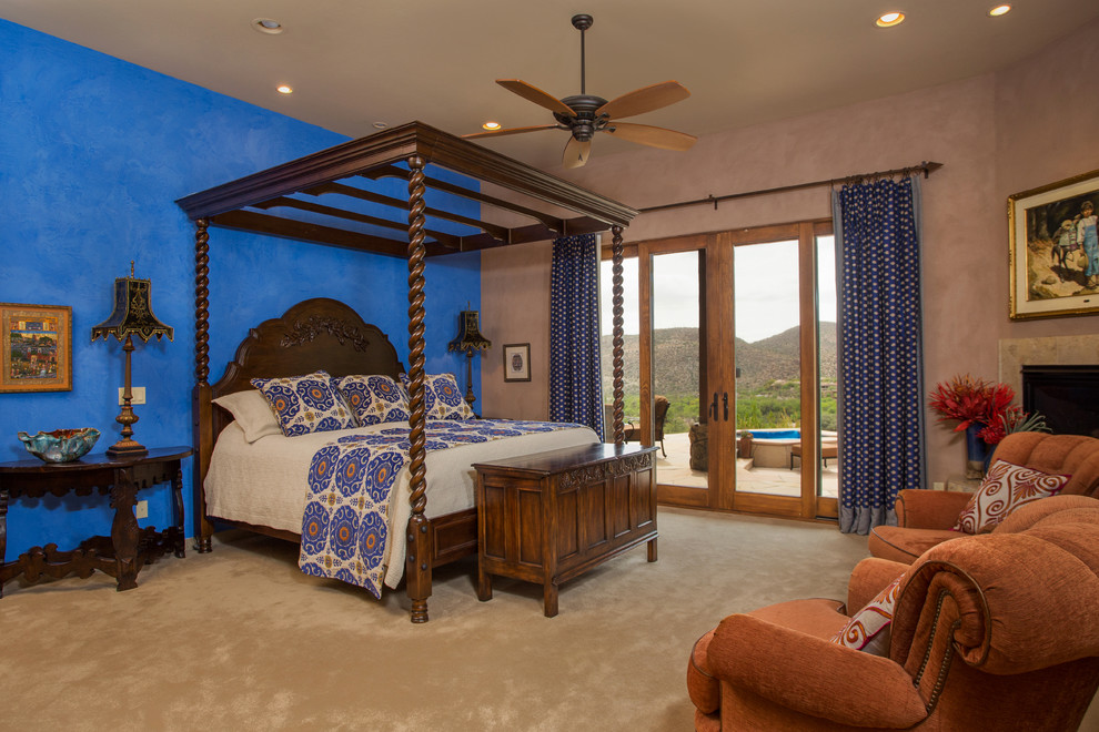 Bedroom - large southwestern master carpeted and beige floor bedroom idea in Phoenix with multicolored walls, a corner fireplace and a tile fireplace