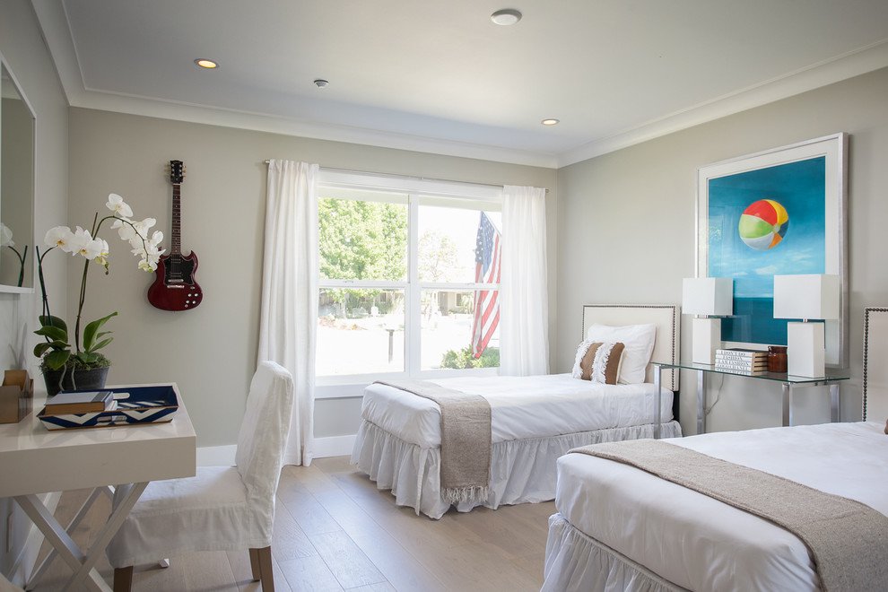 Example of a transitional guest light wood floor bedroom design in Orange County with gray walls