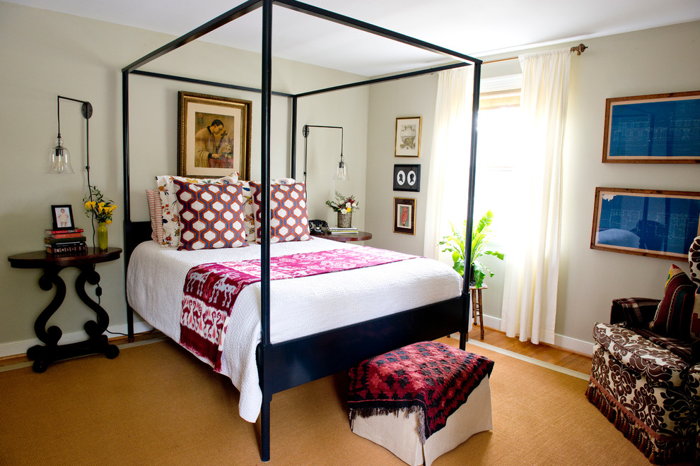 Medium sized bohemian master bedroom in Other with beige walls and medium hardwood flooring.