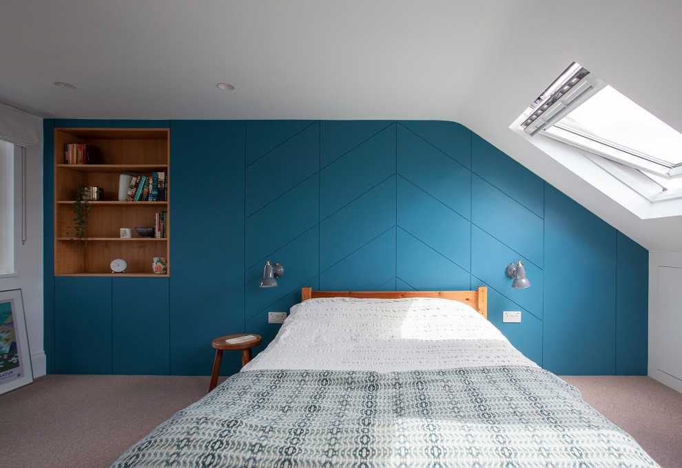 Design ideas for a small midcentury guest bedroom in London with blue walls, carpet, beige floors and panelled walls.