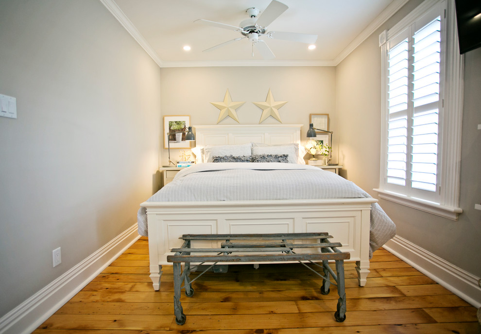 Immagine di una piccola camera degli ospiti design con pareti grigie, parquet chiaro e pavimento giallo