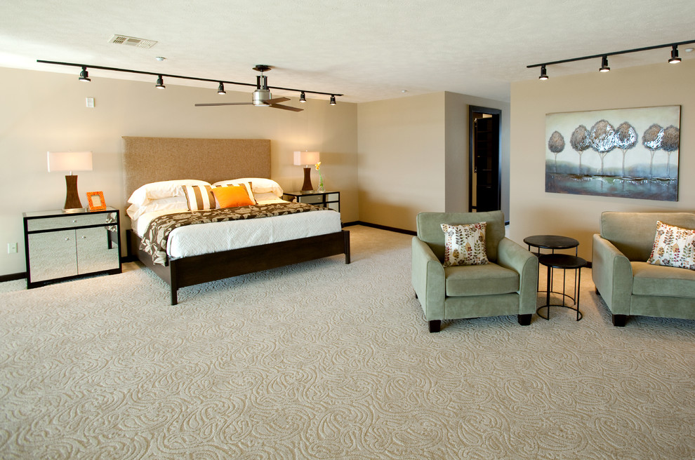 This is an example of a large contemporary master bedroom in Wichita with beige walls, carpet, no fireplace and beige floors.