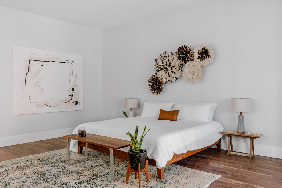 Bedroom - industrial dark wood floor and brown floor bedroom idea in Denver with white walls