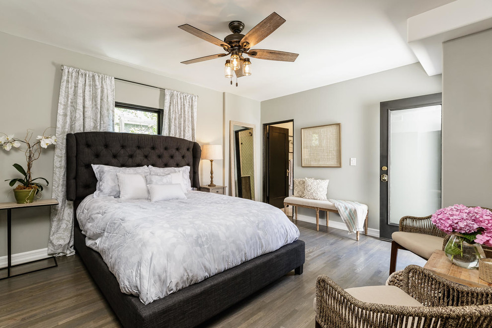 Example of a transitional dark wood floor and gray floor bedroom design in Los Angeles with gray walls and no fireplace