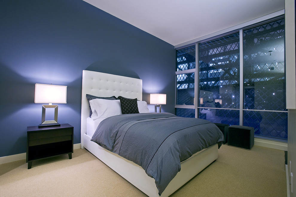 This is an example of a contemporary bedroom in Seattle with blue walls and feature lighting.