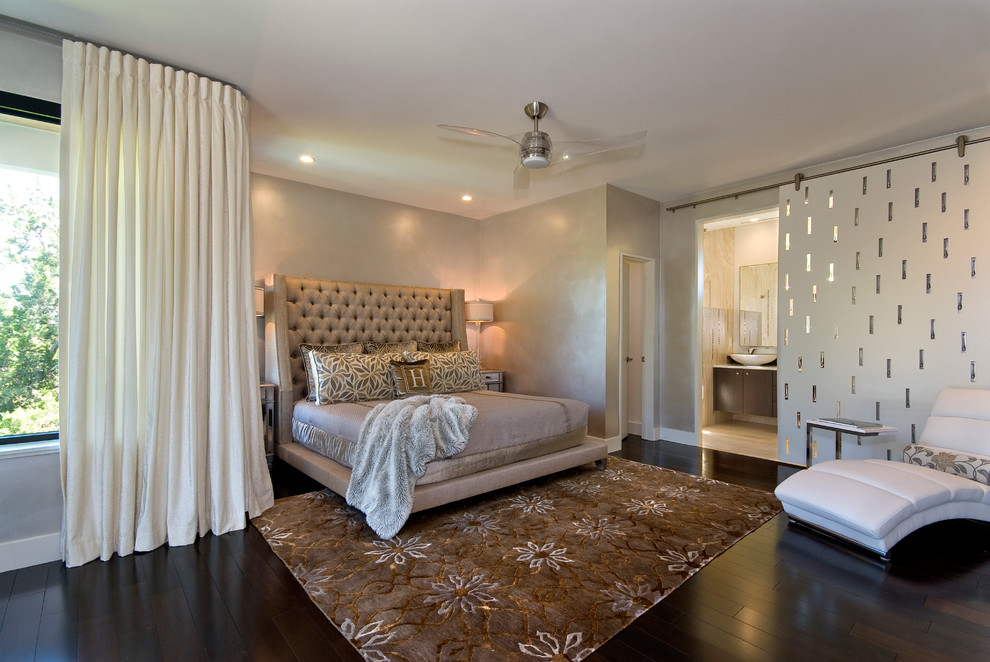 This is an example of a contemporary master bedroom in Baltimore with beige walls and dark hardwood flooring.