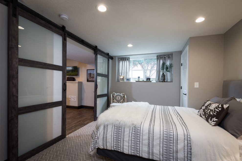 Photo of a medium sized classic guest bedroom in Columbus with grey walls, carpet and brown floors.