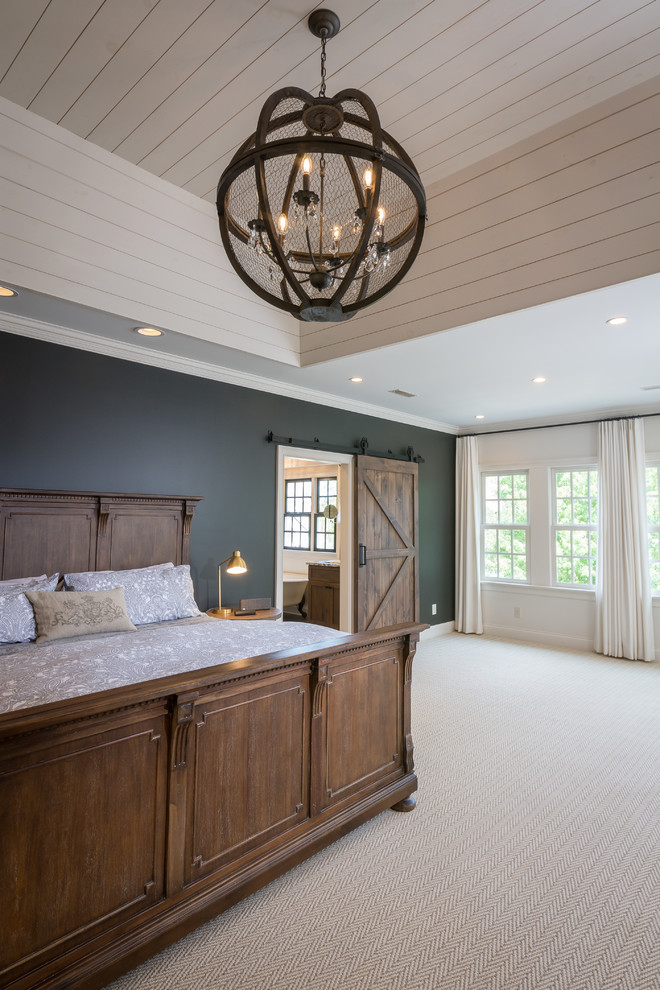 Photo of a large traditional master bedroom in Columbus with white walls, carpet, a standard fireplace, a brick fireplace surround and grey floors.