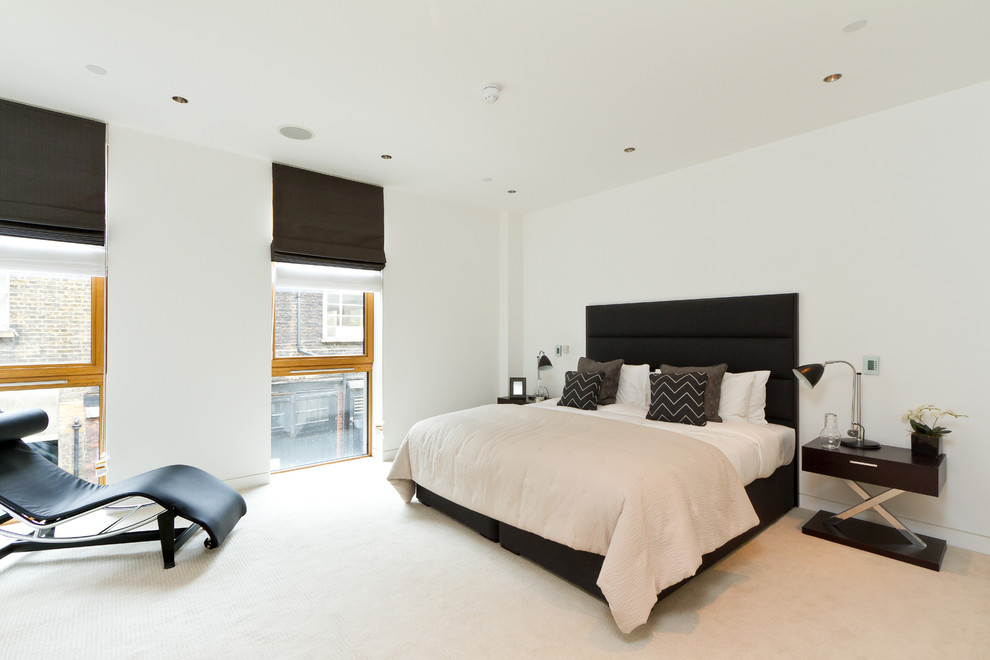 Contemporary bedroom in London with white walls.