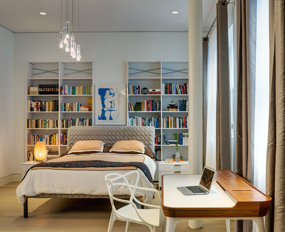 Photo of a contemporary bedroom in New York with white walls and light hardwood flooring.