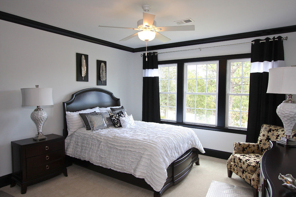 This is an example of a traditional bedroom in Other with white walls and carpet.