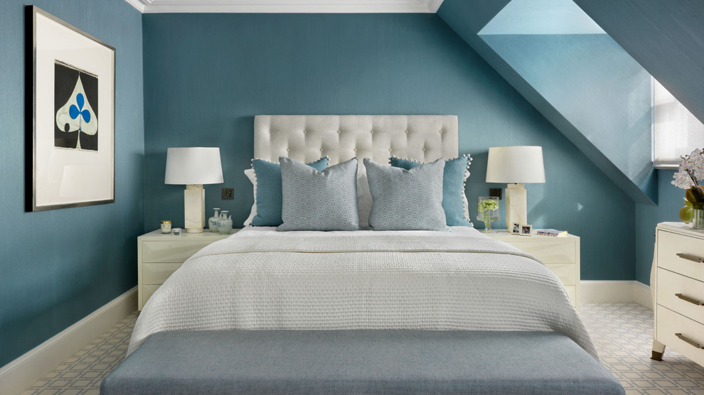Example of a mid-sized transitional guest bedroom design in London with blue walls