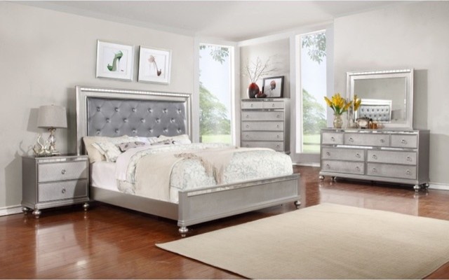Design ideas for a large contemporary master and grey and silver bedroom in Los Angeles with grey walls, medium hardwood flooring, no fireplace and brown floors.