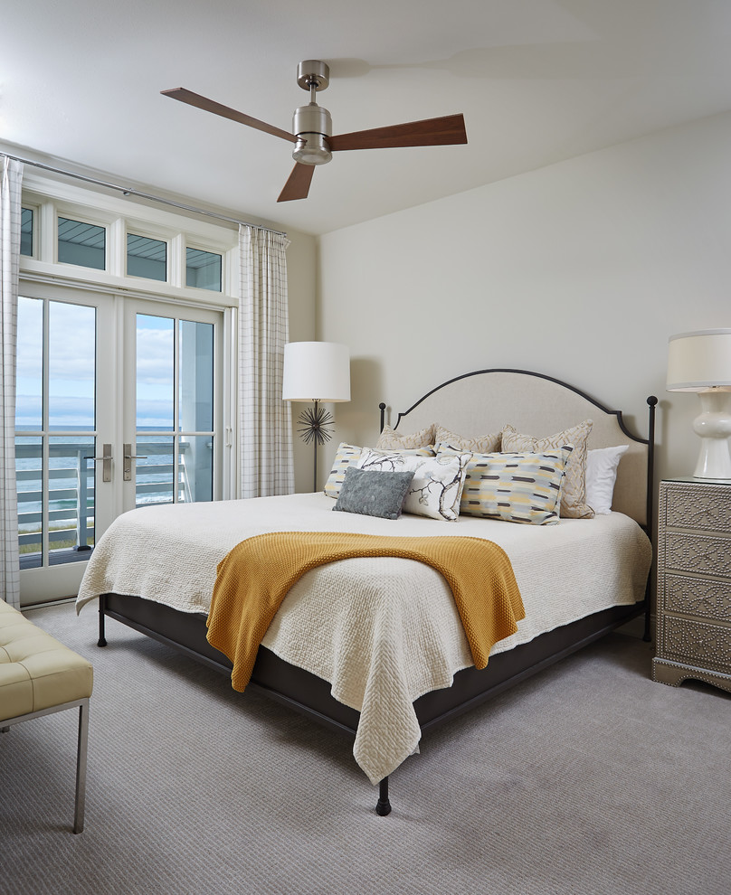 Photo of a beach style guest bedroom in Grand Rapids with white walls and carpet.