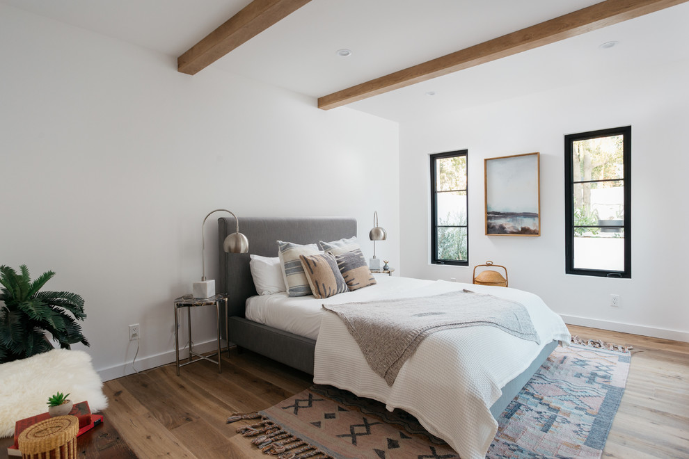 Design ideas for a classic bedroom in Los Angeles with white walls and light hardwood flooring.