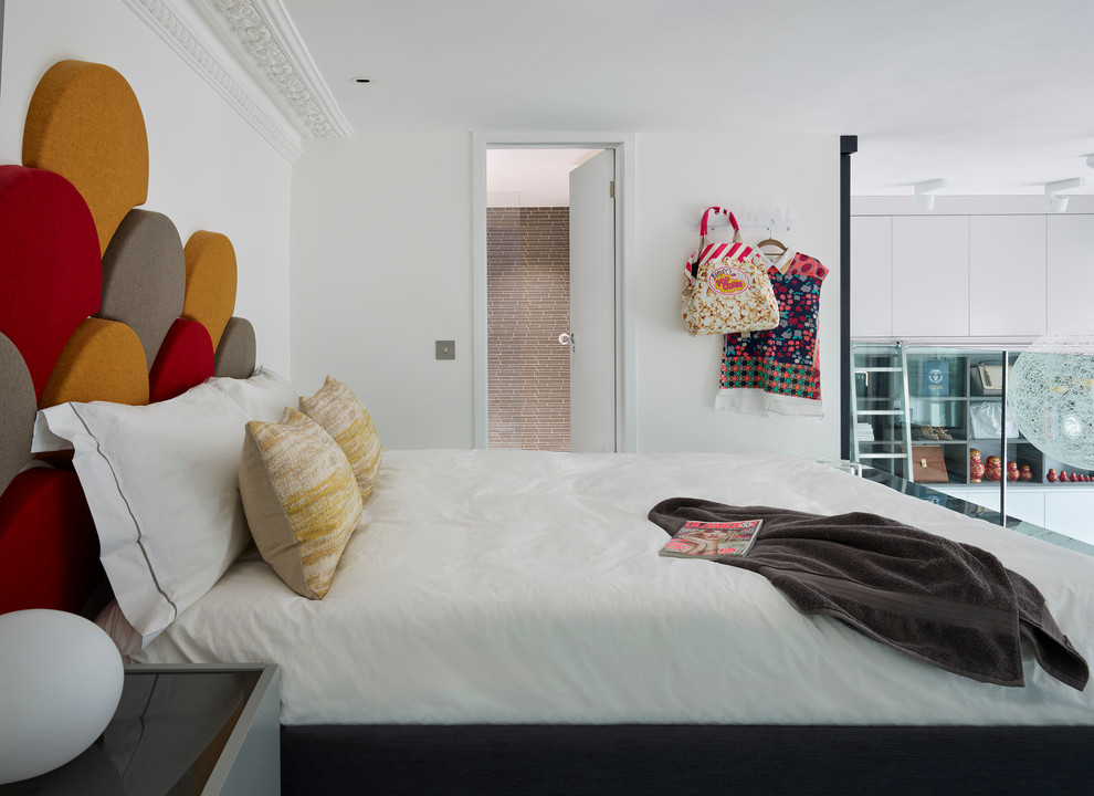 This is an example of a small contemporary mezzanine bedroom in London with white walls.