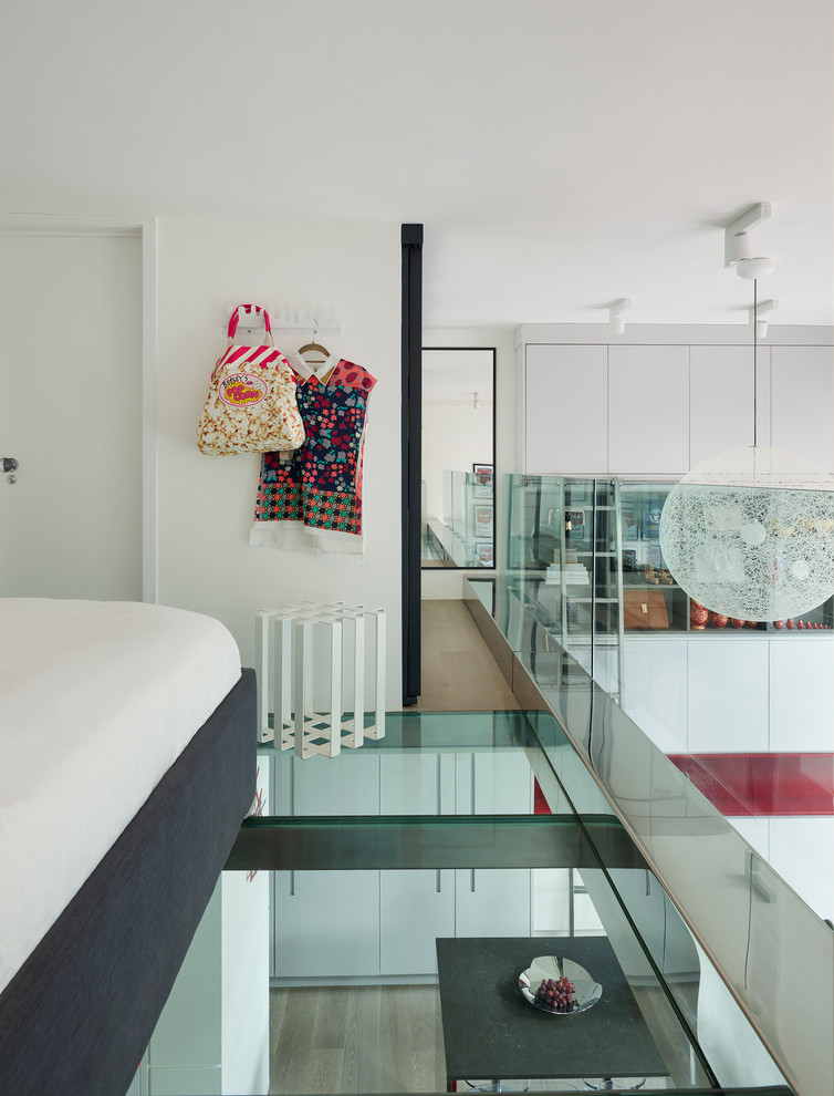 Design ideas for a contemporary mezzanine bedroom in London with white walls.