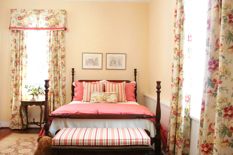 Mid-sized elegant guest medium tone wood floor bedroom photo in Other with beige walls