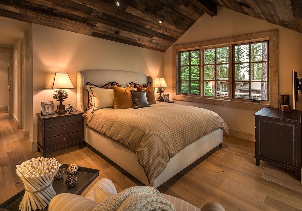 Bedroom - rustic medium tone wood floor bedroom idea in Sacramento with beige walls