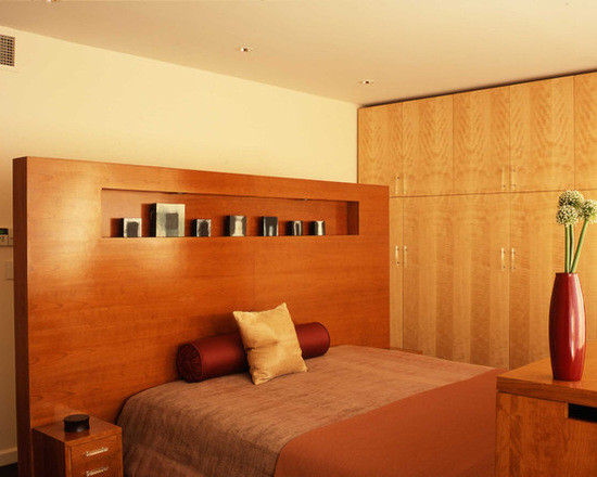 This is an example of a medium sized modern mezzanine bedroom in New York with yellow walls.