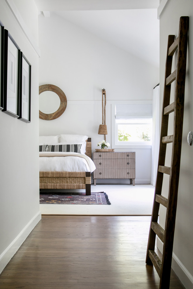 Example of a huge transitional master medium tone wood floor and brown floor bedroom design in New York with white walls and no fireplace