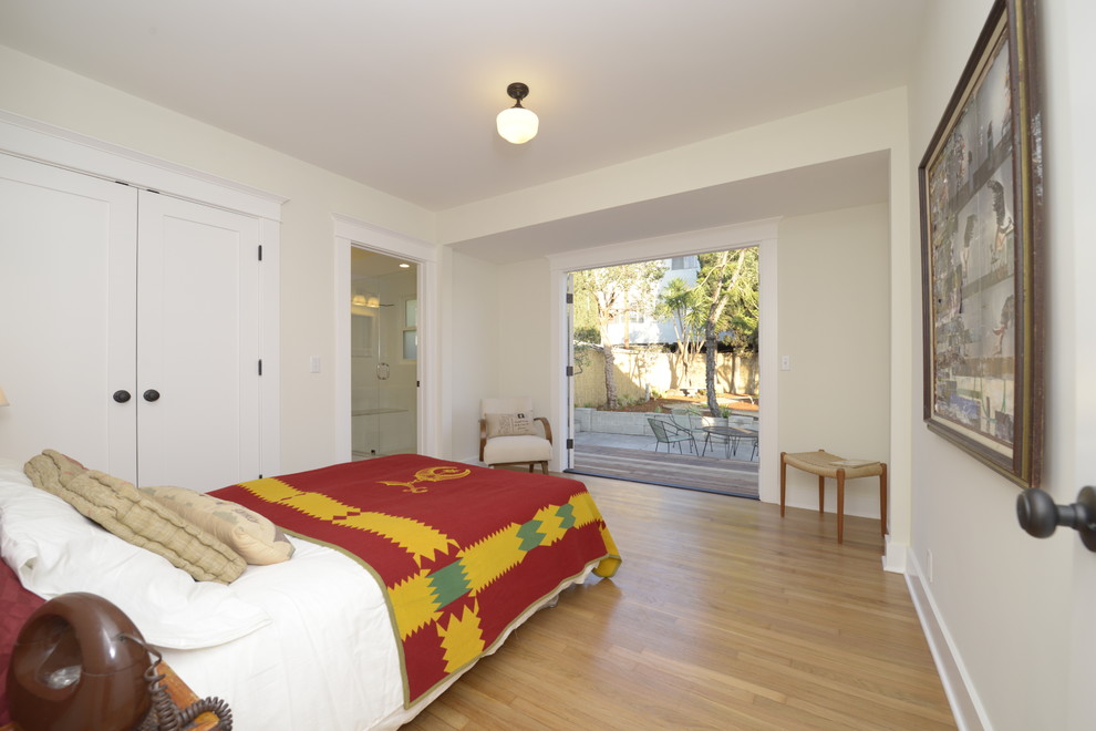 Inspiration for a medium sized classic master bedroom in Los Angeles with white walls and light hardwood flooring.