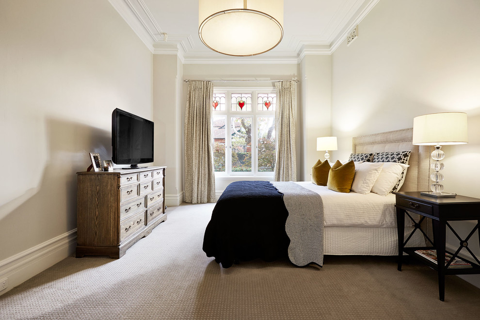 Example of a transitional bedroom design in Melbourne