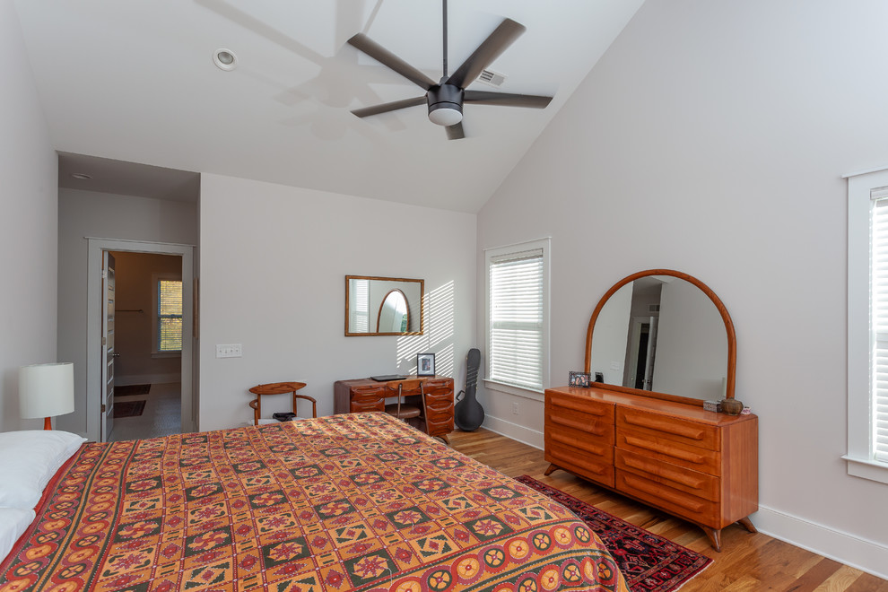 Medium sized nautical master bedroom in Charleston with grey walls, medium hardwood flooring, no fireplace and brown floors.