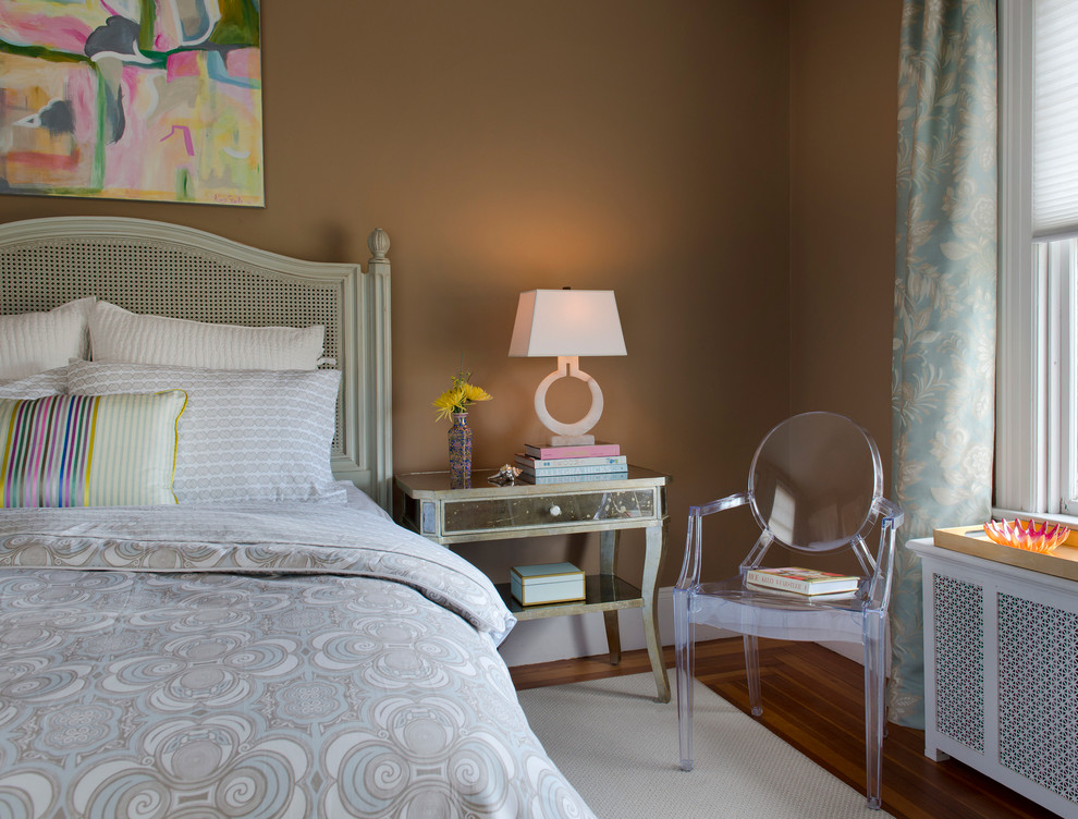 Eclectic bedroom in Providence with beige walls and medium hardwood flooring.