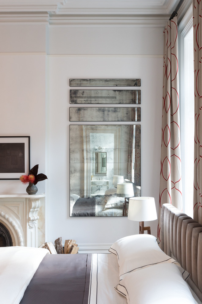 Photo of a medium sized contemporary master bedroom in New York with white walls, dark hardwood flooring, a standard fireplace and a plastered fireplace surround.