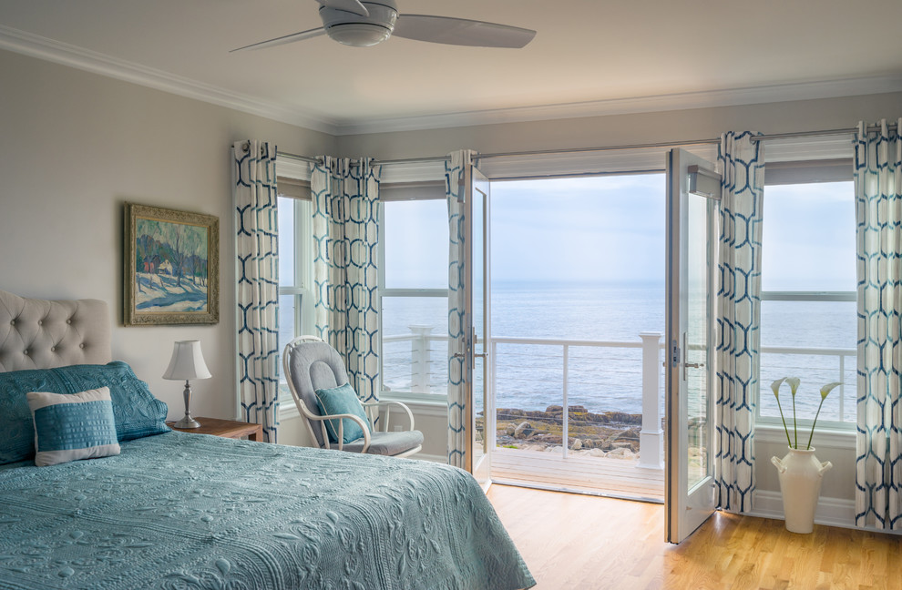 Design ideas for a large coastal master bedroom in Boston with beige walls, light hardwood flooring and no fireplace.