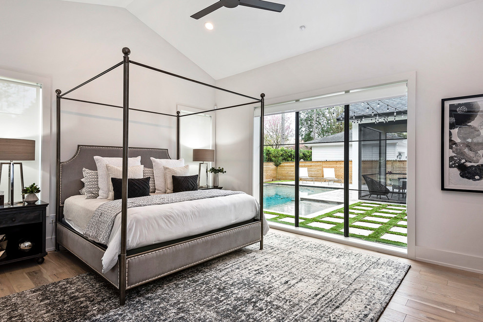 Mid-sized master light wood floor bedroom photo in Orlando with white walls