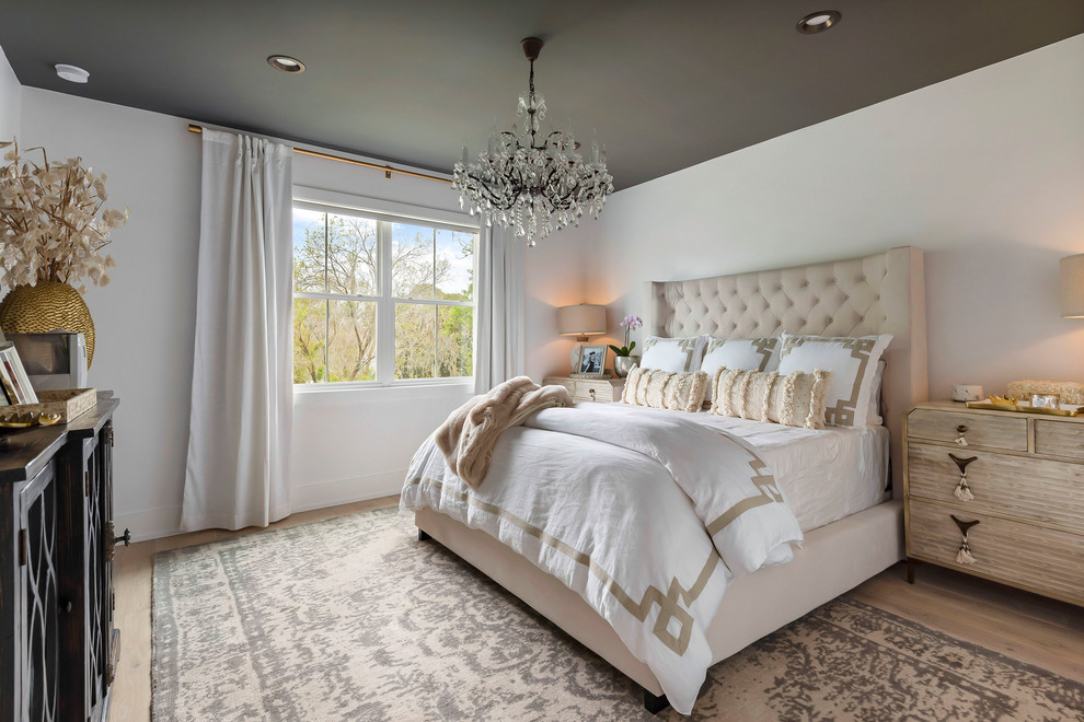Inspiration for a large master bedroom remodel in Orlando with white walls