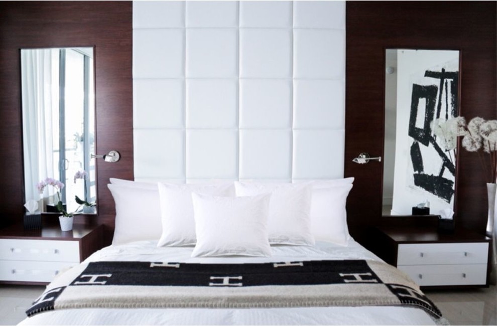 This is an example of a large modern master bedroom in Miami with beige floors.