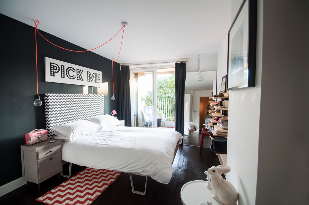 This is an example of a small eclectic master bedroom in London with black walls.