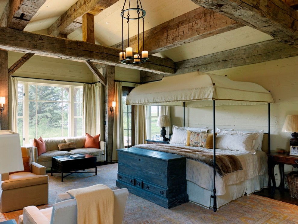 Inspiration for a rustic master bedroom in Jackson with beige walls.