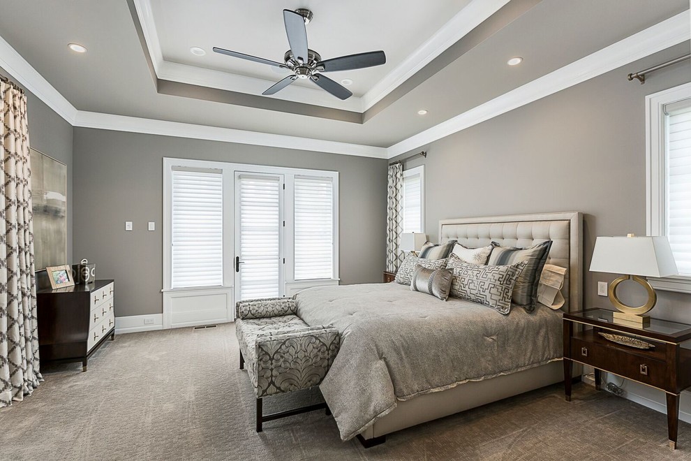 Medium sized traditional master bedroom in Chicago with grey walls, carpet, no fireplace and beige floors.