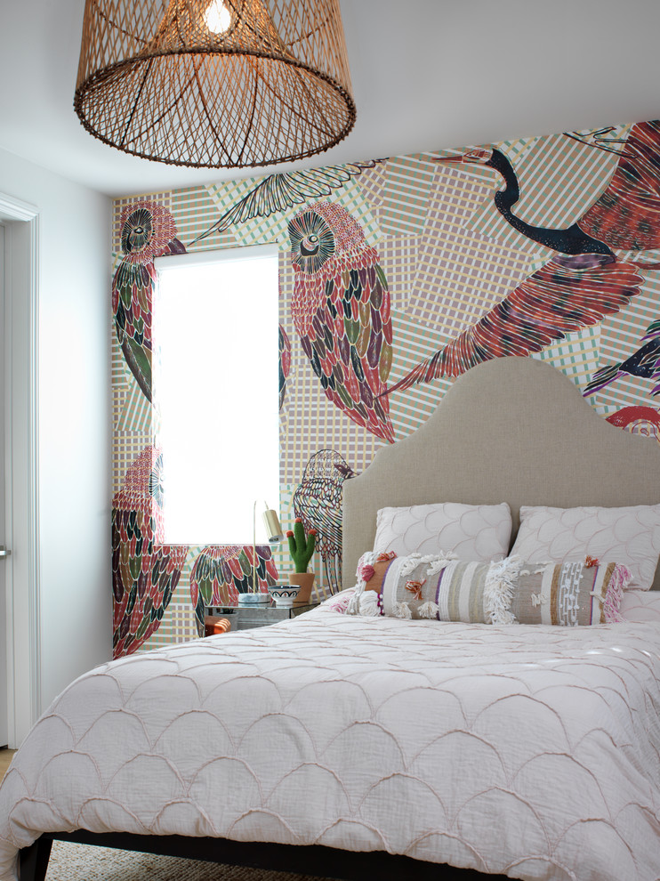 Photo of a traditional bedroom in San Diego with multi-coloured walls, light hardwood flooring and brown floors.