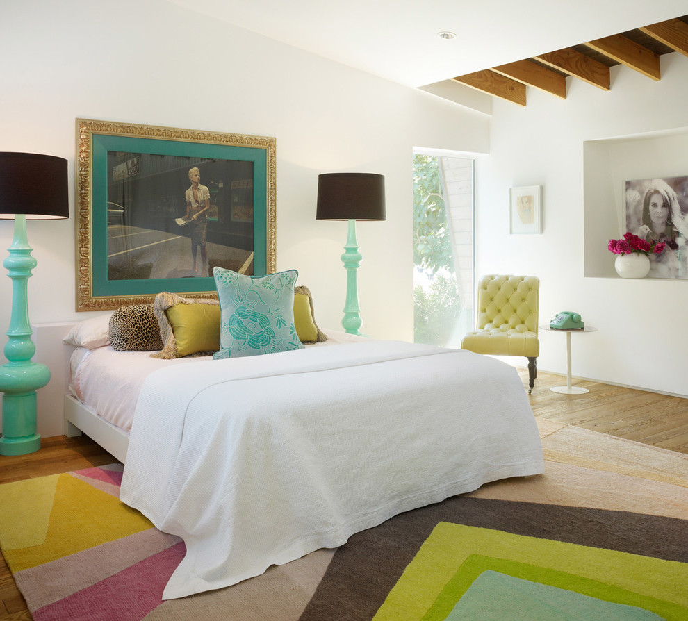 Inspiration for a master and grey and pink bedroom in Los Angeles with white walls and light hardwood flooring.
