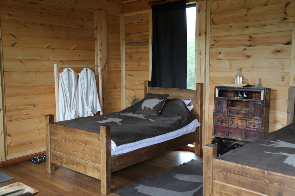 Photo of a medium sized rustic guest bedroom in Other with light hardwood flooring.