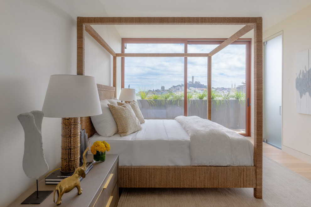 This is an example of a medium sized contemporary master bedroom in San Francisco with white walls and beige floors.
