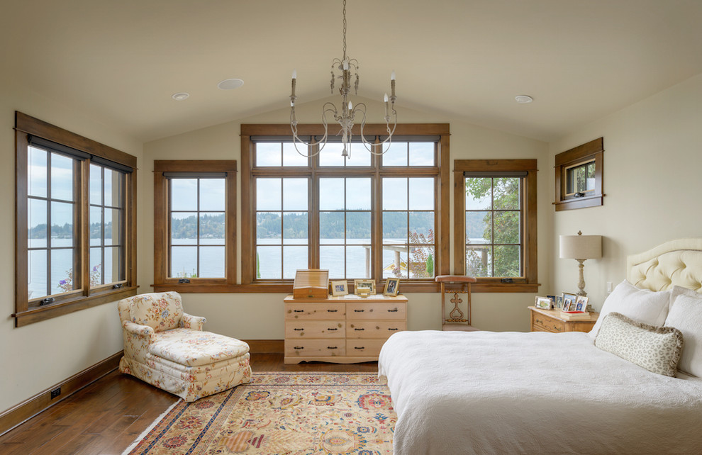 Inspiration for a mediterranean master bedroom in Seattle with beige walls and dark hardwood flooring.