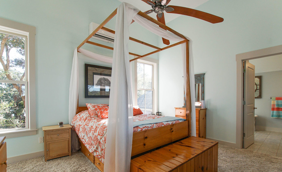 Example of a large beach style master carpeted bedroom design in Charleston with blue walls and no fireplace