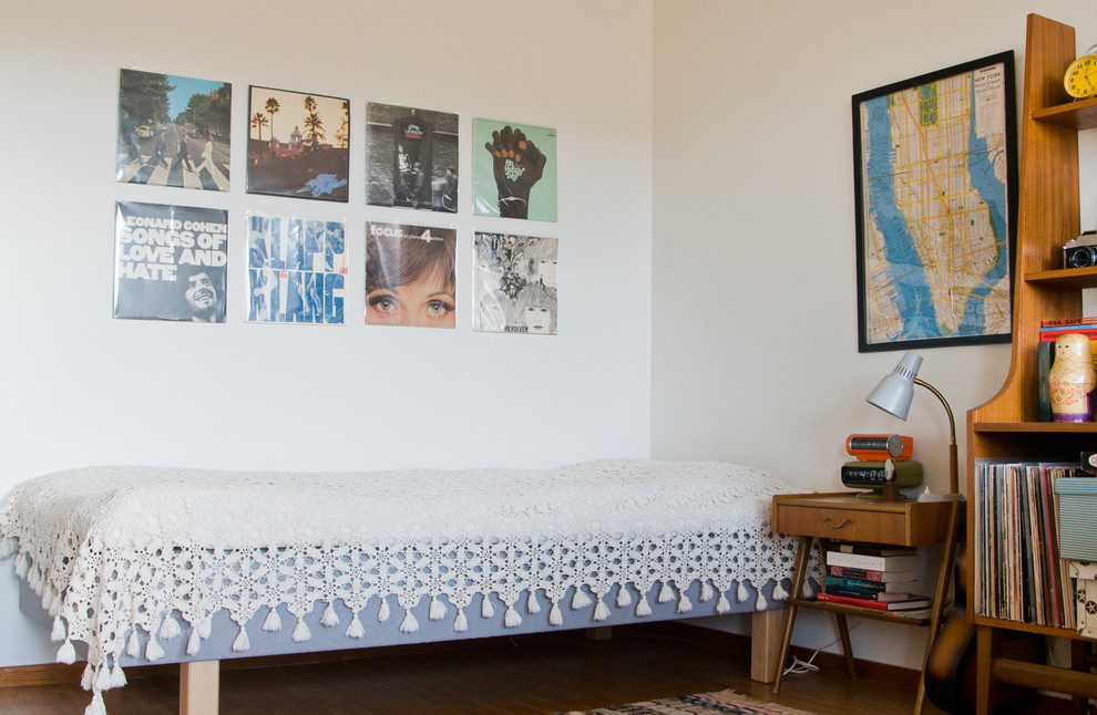 Bedroom - mid-sized 1960s medium tone wood floor bedroom idea in Other with white walls and no fireplace