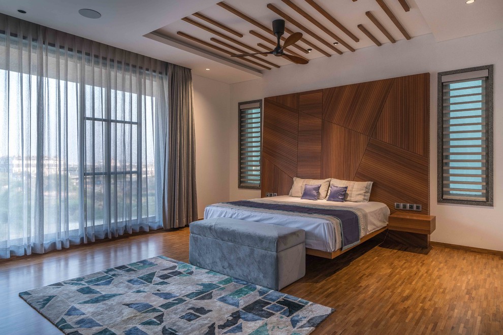 Bedroom - contemporary medium tone wood floor and brown floor bedroom idea in Hyderabad with no fireplace