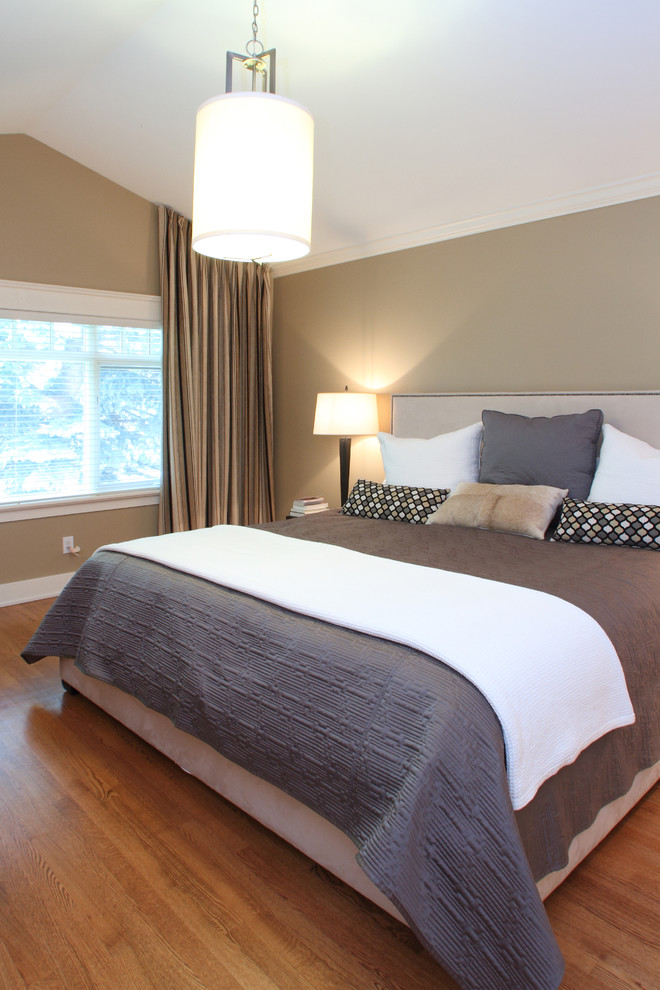 Bedroom - large transitional master medium tone wood floor bedroom idea in Calgary with beige walls and no fireplace
