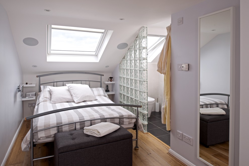 Photo of a small contemporary loft bedroom in London.
